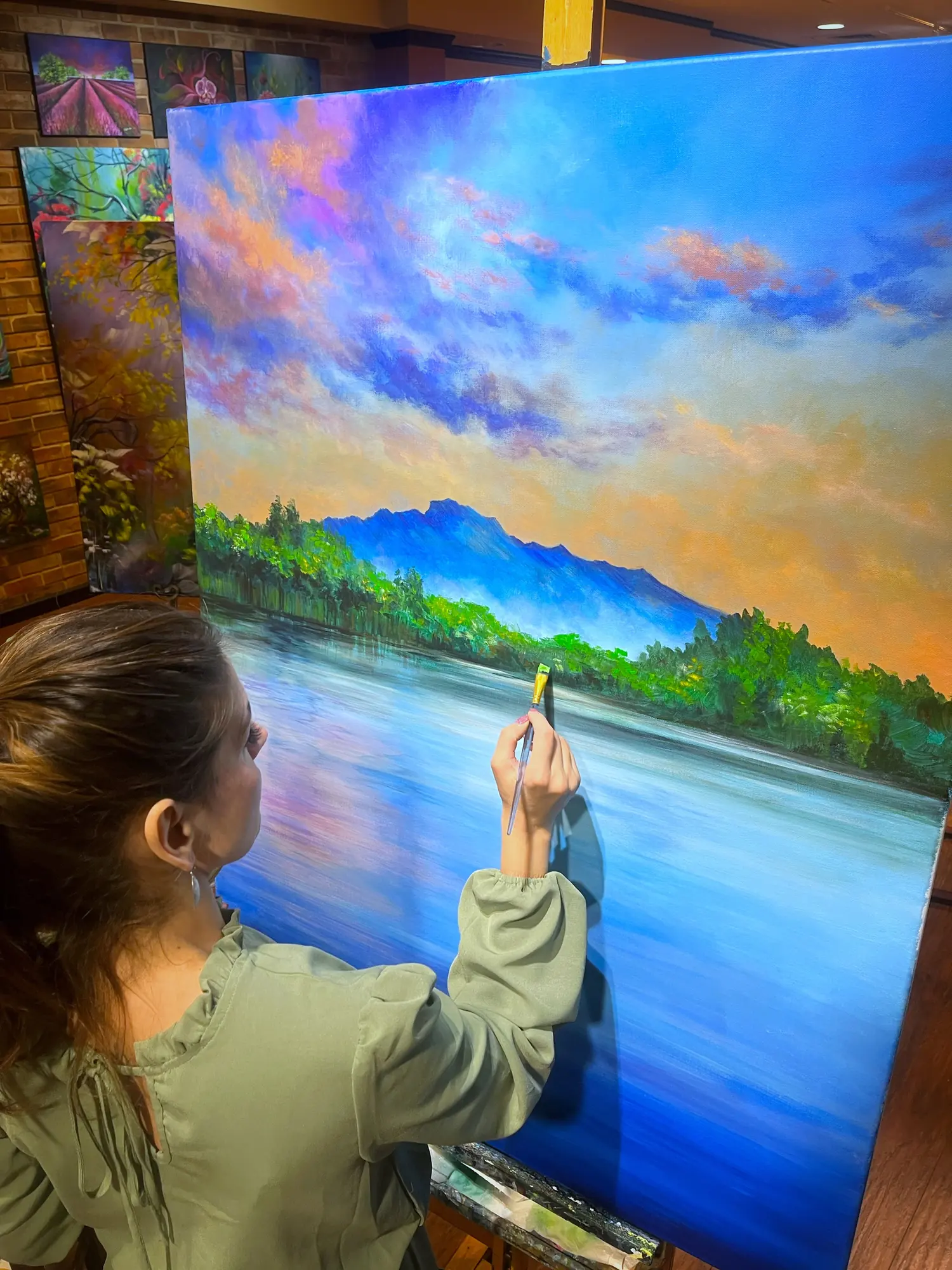 Vesna painting a blue mountain landscape