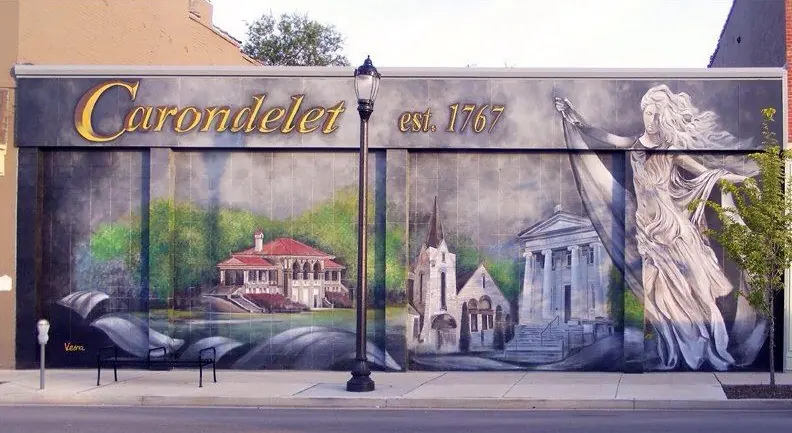 A mural of historic Carondelet buildings on an exterior wall