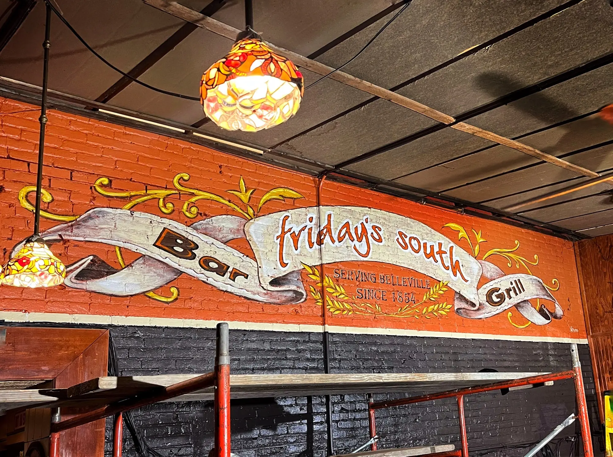 A logo mural for Friday's South inside a restaurant